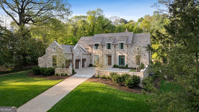41 Blackland Rd NW, Atlanta, GA 30342 - view of front of home with concrete driveway, a front lawn, stone siding, and a garage