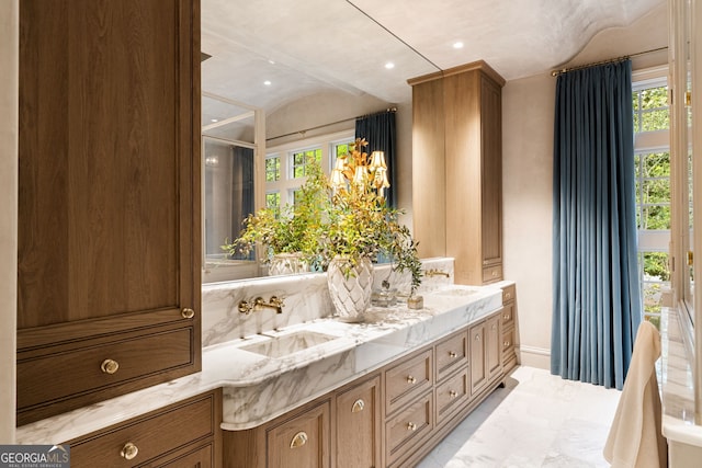 41 Blackland Rd NW, Atlanta, GA 30342 - bathroom featuring recessed lighting, marble finish floor, double vanity, vaulted ceiling, and a sink