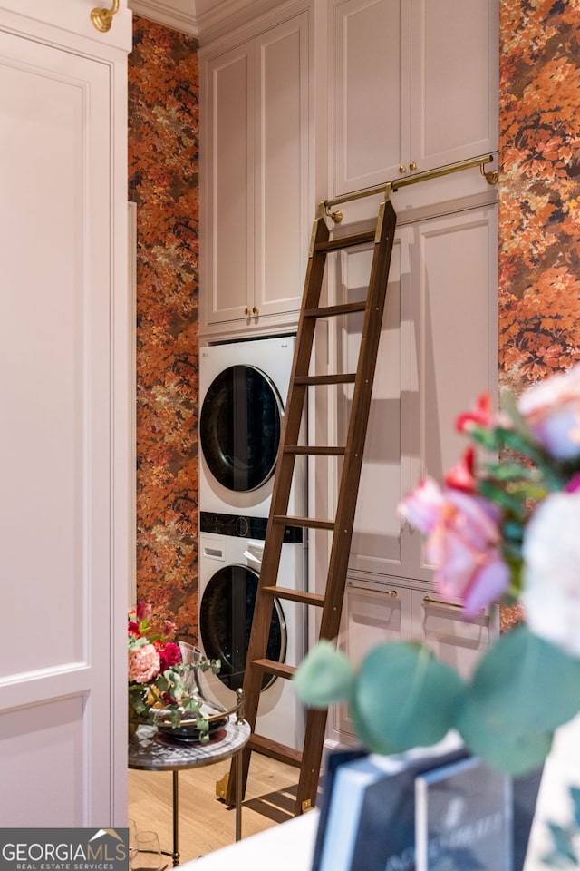 41 Blackland Rd NW, Atlanta, GA 30342 - laundry room featuring cabinet space, stacked washer and dryer, and wallpapered walls