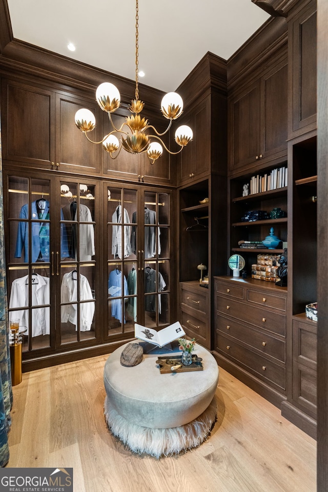 41 Blackland Rd NW, Atlanta, GA 30342 - walk in closet with a chandelier and light wood finished floors