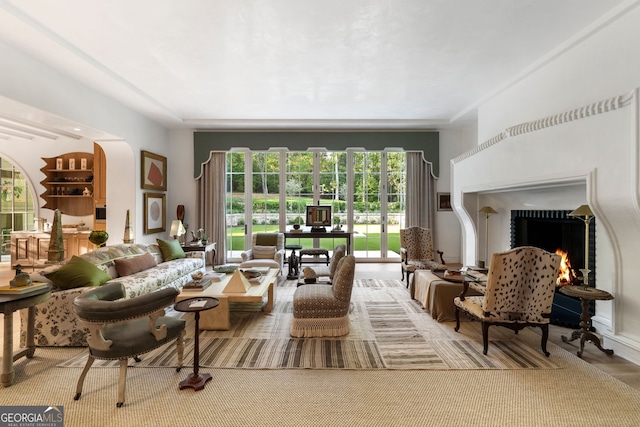 41 Blackland Rd NW, Atlanta, GA 30342 - living room featuring arched walkways and a lit fireplace