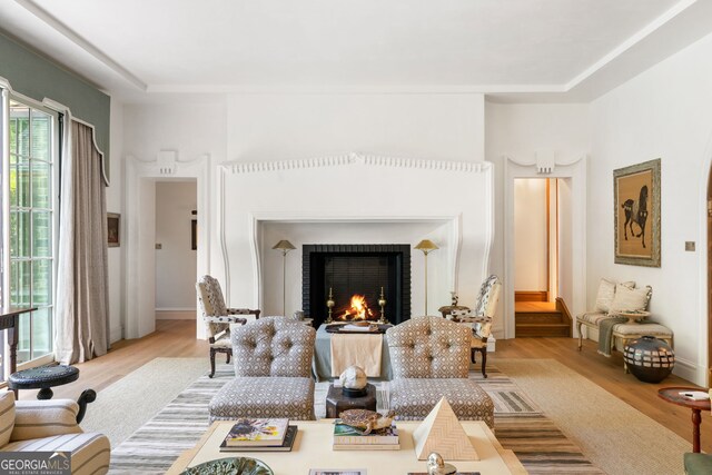 41 Blackland Rd NW, Atlanta, GA 30342 - living room featuring a warm lit fireplace, wood finished floors, and baseboards