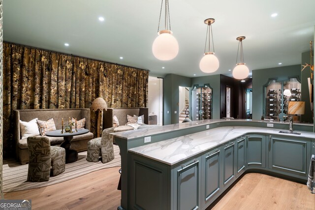 41 Blackland Rd NW, Atlanta, GA 30342 - kitchen featuring open floor plan, light stone countertops, hanging light fixtures, and light wood finished floors
