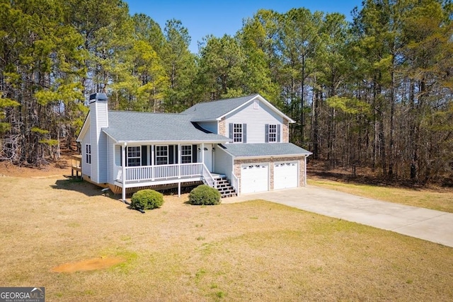 split level home featuring a front lawn, a porch, concrete driveway, a chimney, and a garage