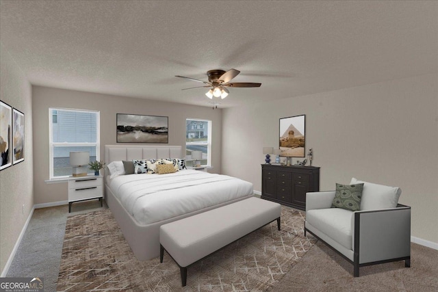 bedroom with ceiling fan, carpet flooring, baseboards, and a textured ceiling