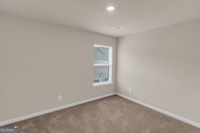 carpeted spare room featuring recessed lighting, visible vents, baseboards, and a textured ceiling