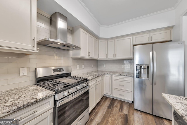 kitchen featuring dark wood-style floors, stainless steel appliances, crown molding, wall chimney range hood, and backsplash