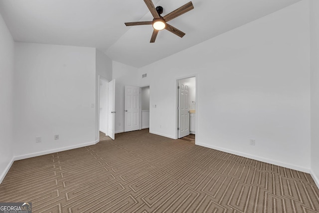 unfurnished bedroom with visible vents, connected bathroom, carpet, baseboards, and vaulted ceiling