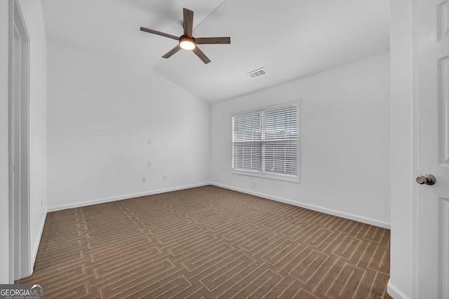 spare room featuring baseboards, visible vents, and ceiling fan