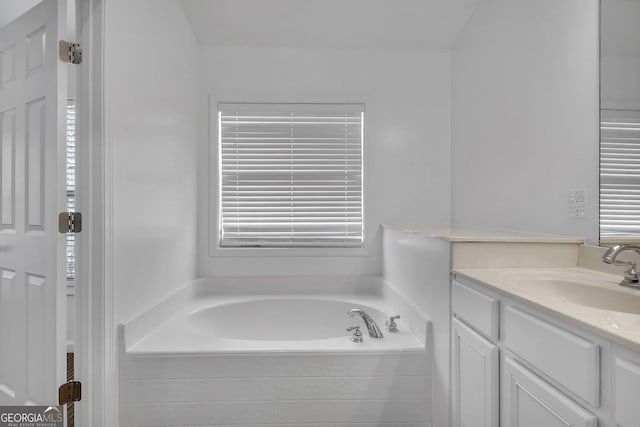 bathroom with vanity and a garden tub