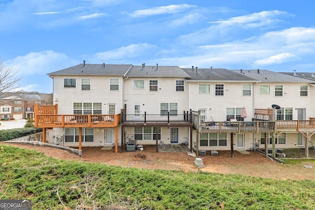 rear view of property with a deck, cooling unit, and a residential view