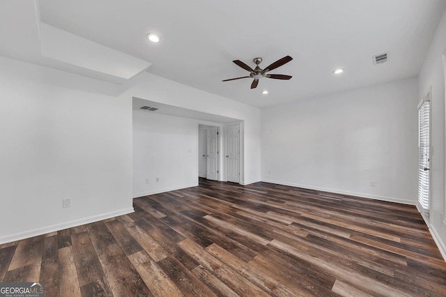 empty room featuring visible vents, recessed lighting, a ceiling fan, and dark wood-style flooring