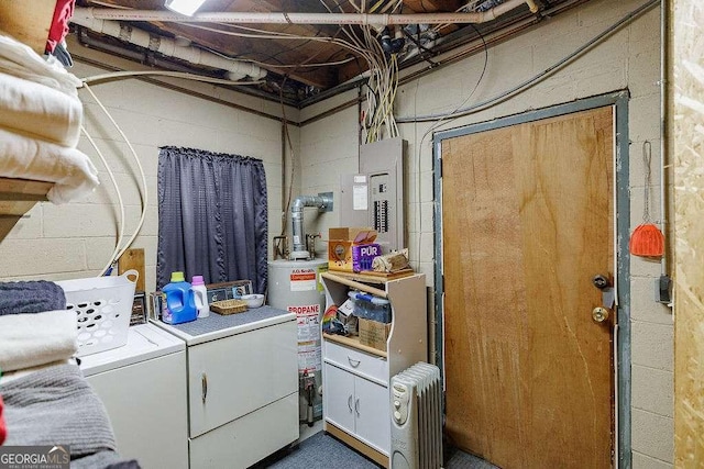 clothes washing area with radiator heating unit, cabinet space, independent washer and dryer, and water heater