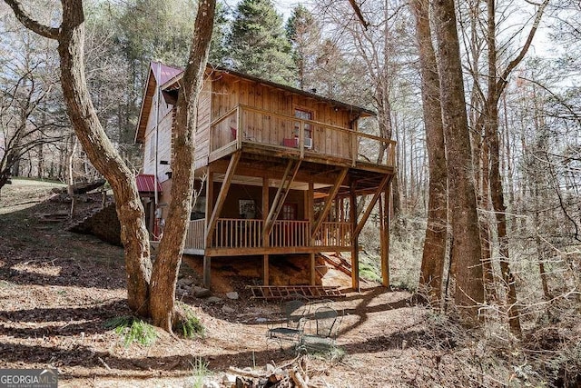 back of house with stairs and a wooden deck