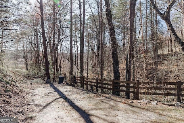 exterior space with a wooded view and fence