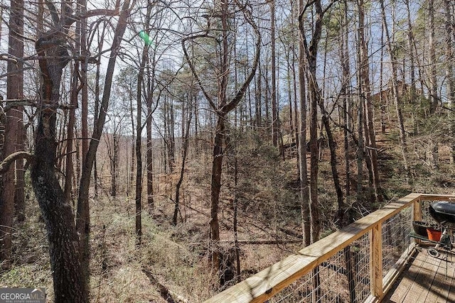 wooden deck featuring a wooded view