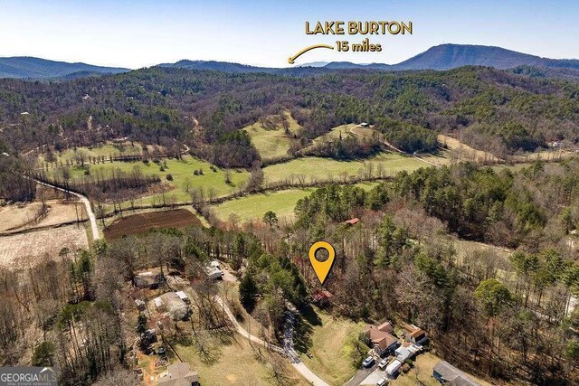 aerial view featuring a mountain view and a forest view