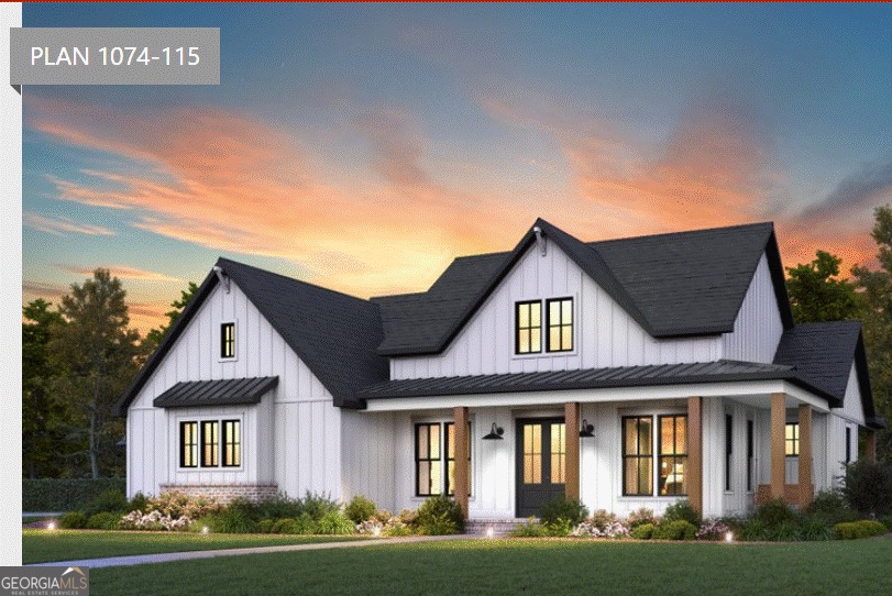 modern inspired farmhouse with a yard, board and batten siding, metal roof, and a standing seam roof