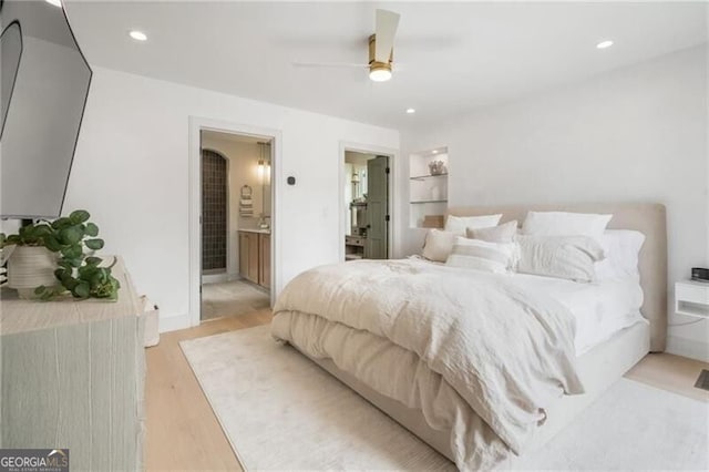 bedroom with recessed lighting, light wood-style flooring, a ceiling fan, and connected bathroom