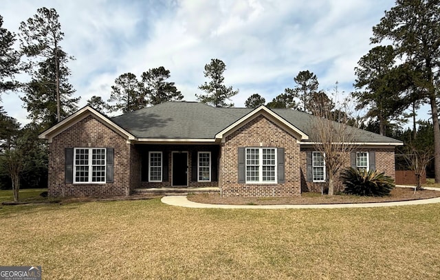 ranch-style house featuring a front yard and brick siding