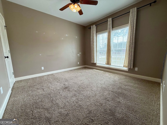 unfurnished room featuring baseboards, ceiling fan, and carpet flooring