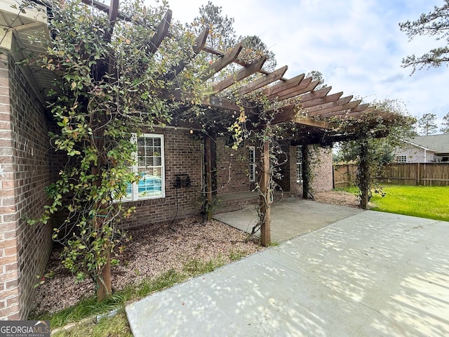 view of patio / terrace featuring a pergola and fence