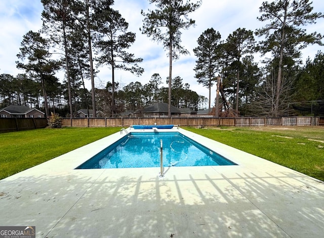 view of pool featuring a patio area, a lawn, a fenced in pool, and a fenced backyard