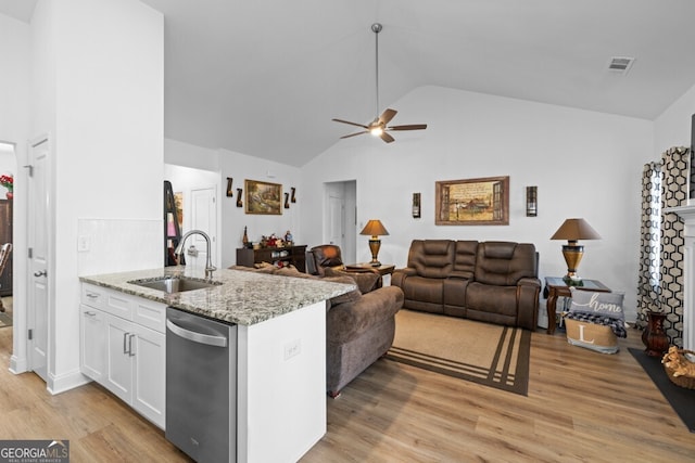 kitchen featuring visible vents, a sink, white cabinets, stainless steel dishwasher, and light wood-type flooring