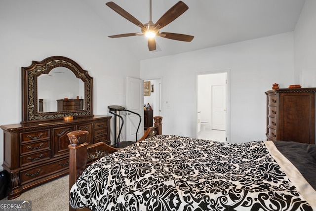 carpeted bedroom featuring ensuite bathroom, ceiling fan, and vaulted ceiling