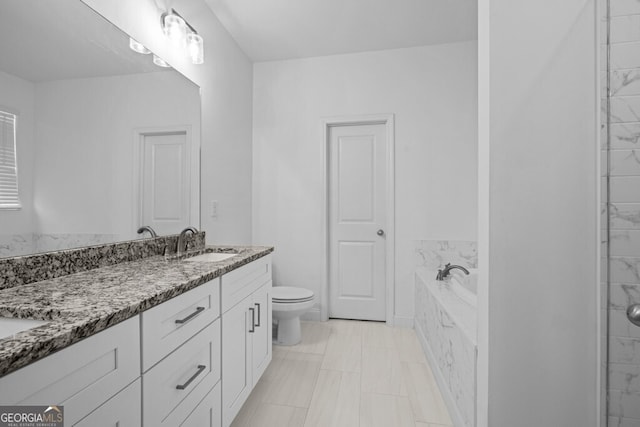 bathroom with a bath, toilet, and vanity