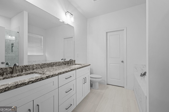 bathroom featuring a bath, a shower stall, double vanity, and a sink