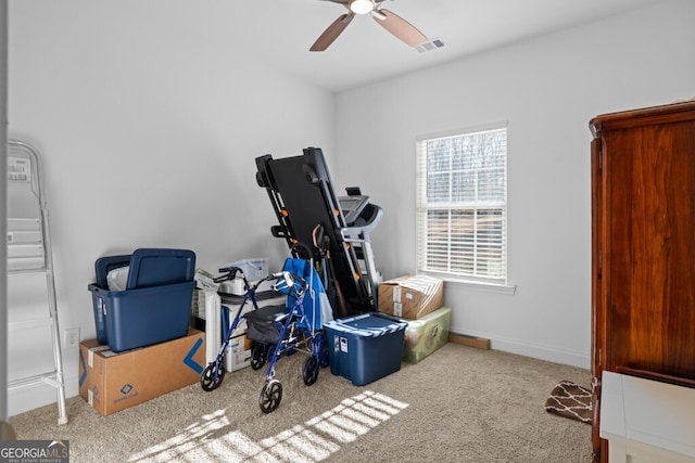 exercise room with a ceiling fan, carpet, visible vents, and baseboards