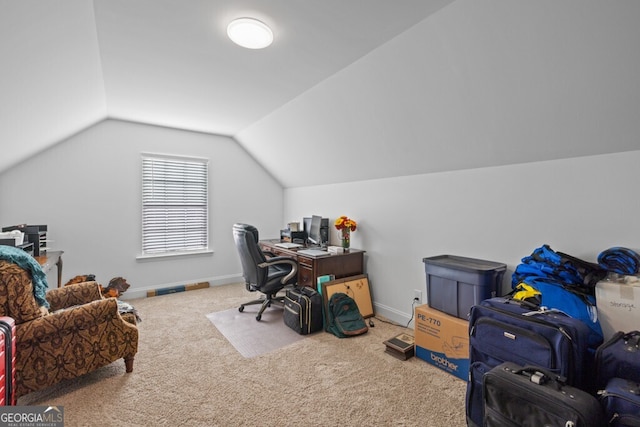 carpeted home office with baseboards and vaulted ceiling