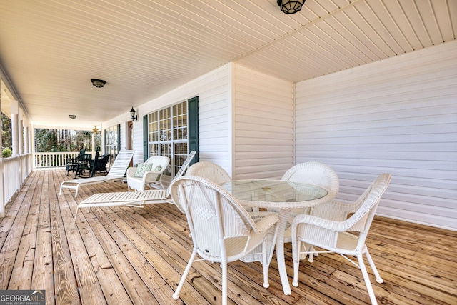 wooden deck featuring outdoor dining area