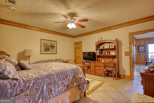 bedroom with fridge, visible vents, a textured ceiling, and ornamental molding