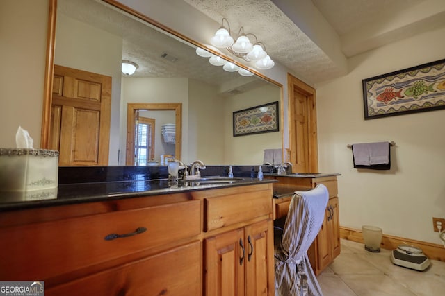 bathroom with visible vents, a textured ceiling, tile patterned flooring, baseboards, and vanity