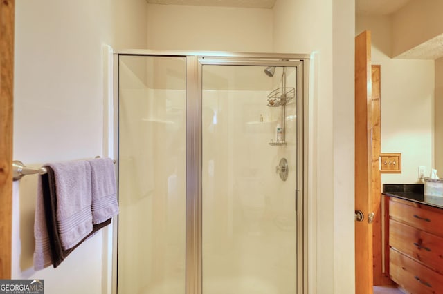 bathroom featuring a stall shower and vanity