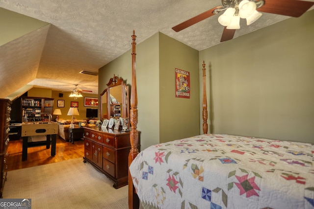 bedroom with visible vents, a textured ceiling, and light wood-style floors