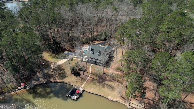 aerial view with a wooded view and a water view