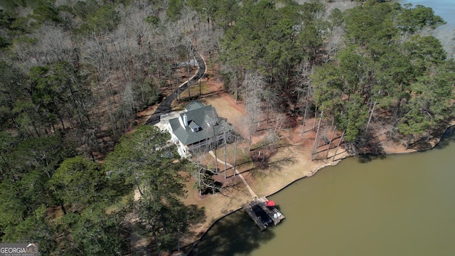 drone / aerial view with a water view and a wooded view