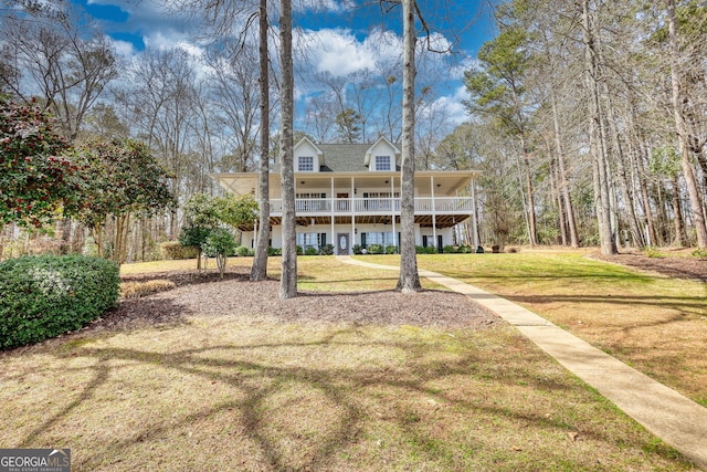 rear view of house with a yard and covered porch