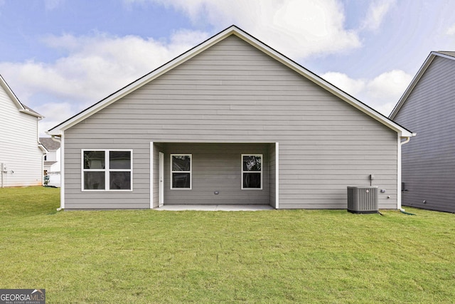 rear view of house featuring a yard, a patio, and central AC