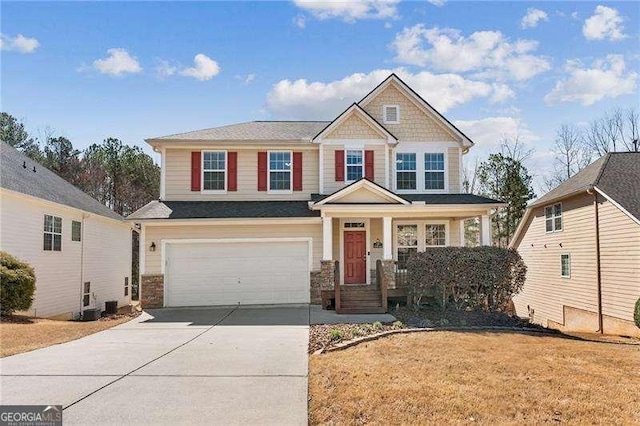 craftsman house with covered porch, concrete driveway, and an attached garage