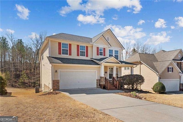 view of front of property featuring a porch, an attached garage, and driveway