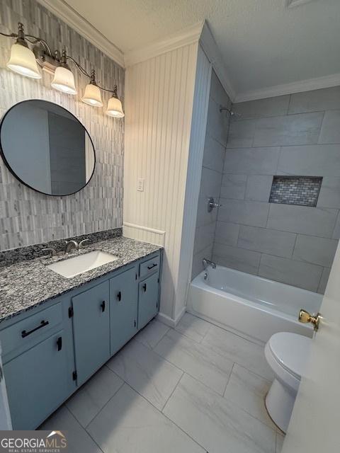 bathroom featuring vanity, tub / shower combination, a textured ceiling, crown molding, and toilet