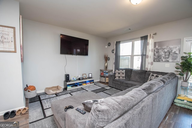 living room featuring visible vents, wood finished floors, and baseboards