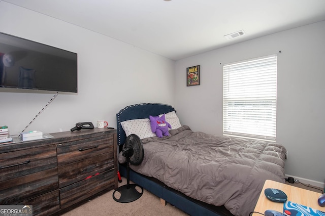 carpeted bedroom featuring visible vents