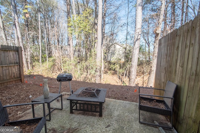 view of patio / terrace with an outdoor fire pit and fence