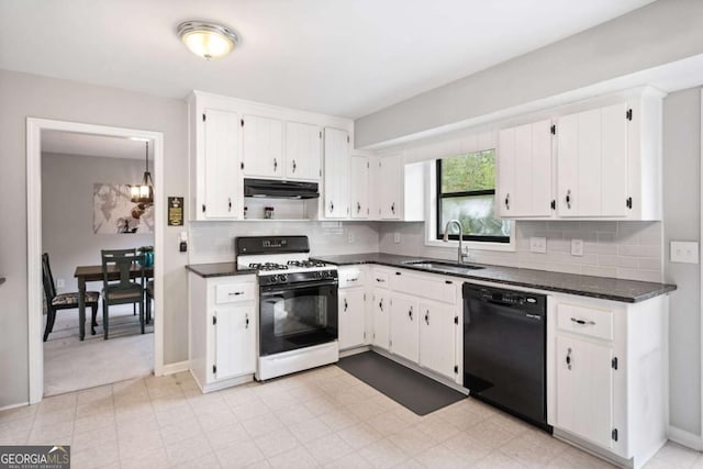 kitchen featuring under cabinet range hood, a sink, black dishwasher, dark countertops, and range with gas cooktop