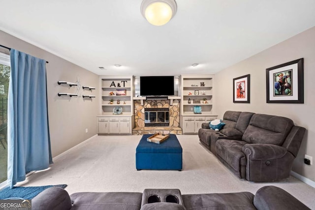 living area featuring a stone fireplace, built in features, carpet, and baseboards